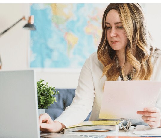 Travel agent working with documents at office.